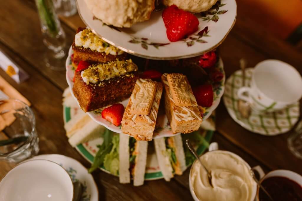 afternoon tea laid out on a three tier vintage china cake stand
