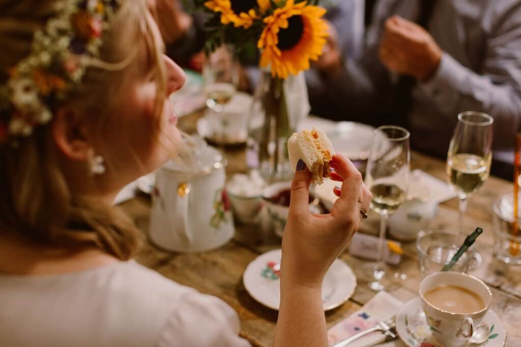 bride eating a sandwich at her wedding